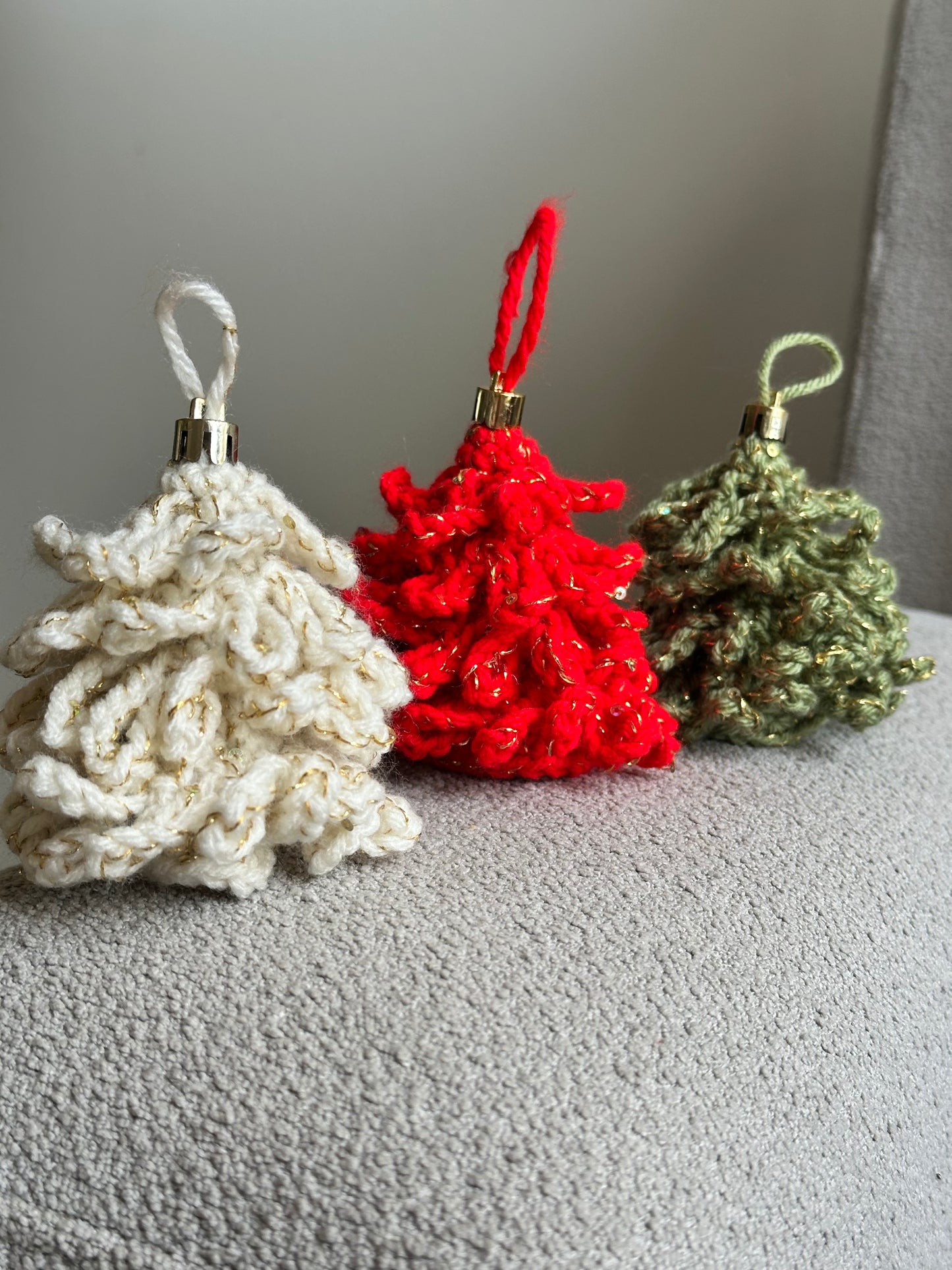 Crochet Christmas ornaments set of three placed together on a soft surface — cozy handmade holiday decor