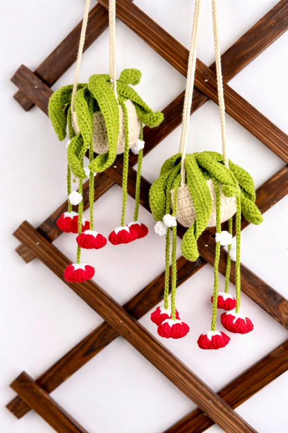 Full view of three finished hanging red bells plants made from DIY Crochet Kit Red Bells Plant, arranged on wooden display.
