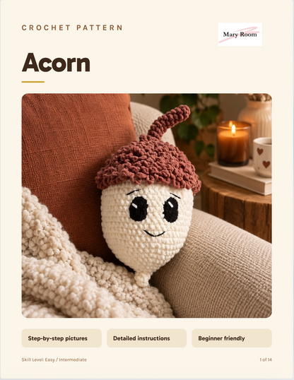 Promotional cover for a crochet pattern titled 'Acorn' by Mary Room, showing a crocheted acorn character with a cream body and brown cap resting on a couch beside a candle and blanket.