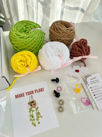 All components of the Crochet KIT Plush Plant with Daisy Flowers shown on a table, ready for use.
