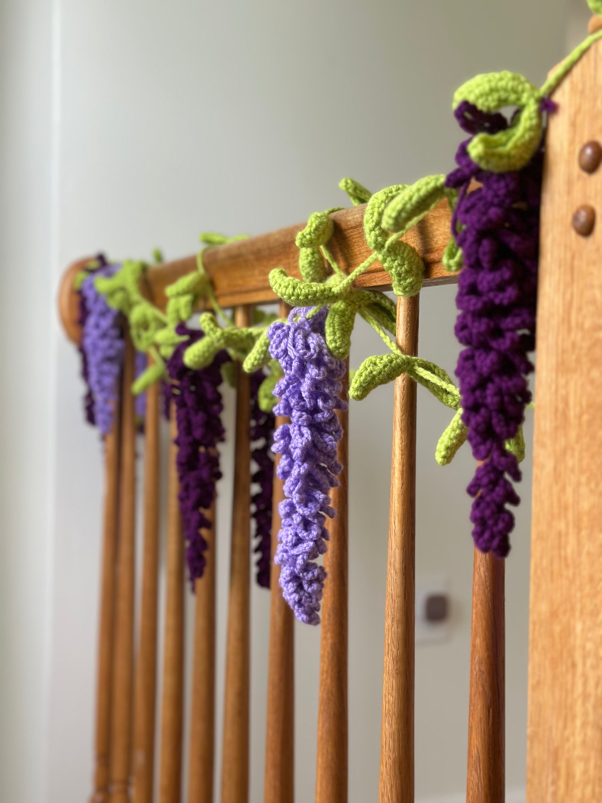 wisteria crochet hanging decor displayed on a wooden wall