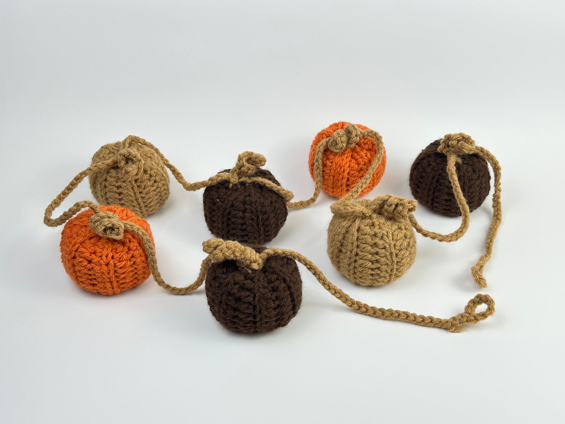 Crocheted pumpkins on a white background