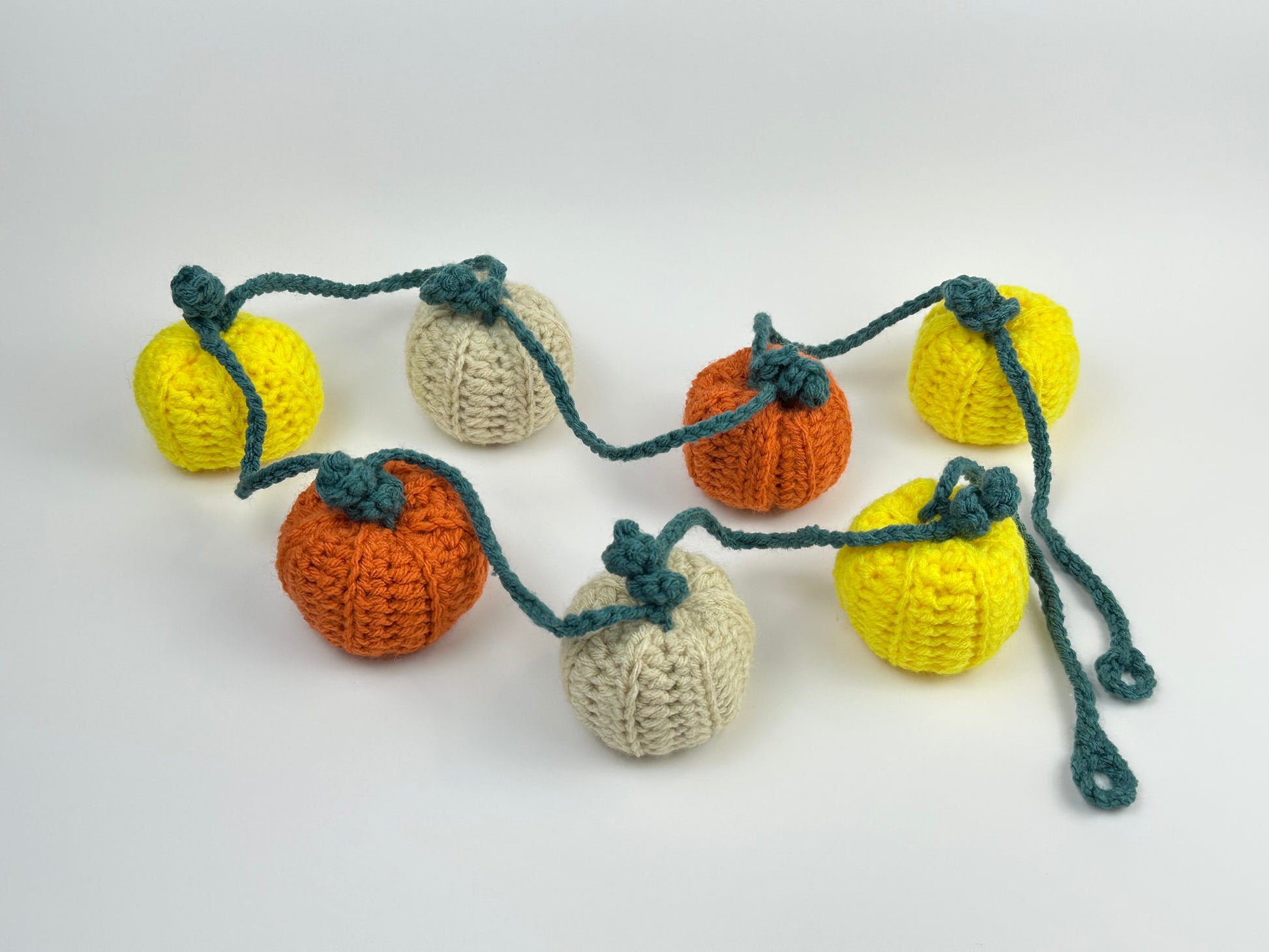 Crocheted pumpkins wall decor on a white background