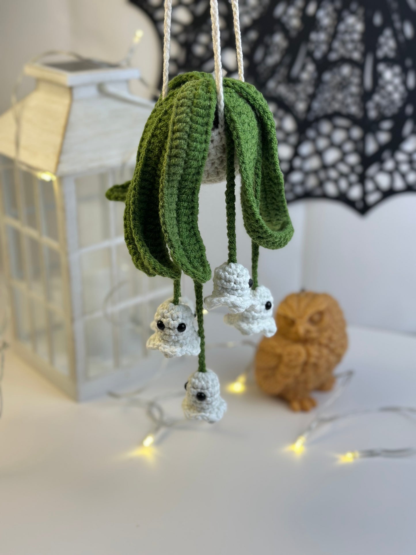 Cozy Halloween decor featuring crochet ghost ornaments.