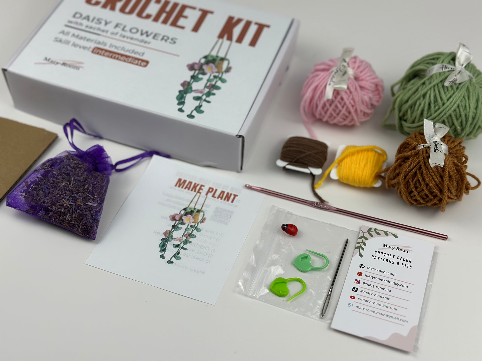 Crochet kit with yarn, hooks, and instructions on a white surface