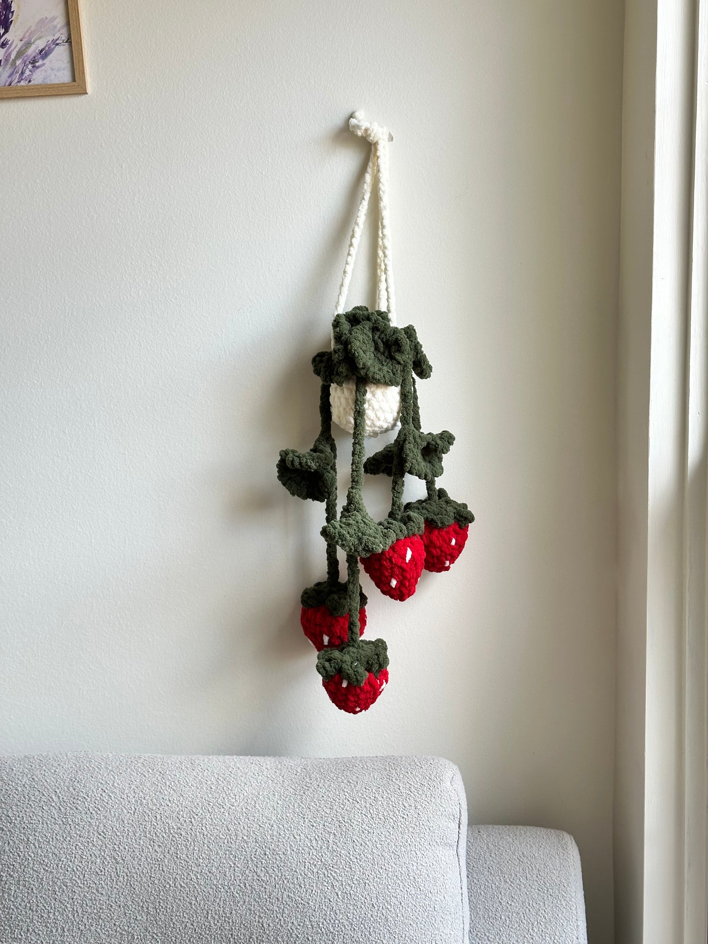 Crochet plush hanging plant with strawberries and green leaves