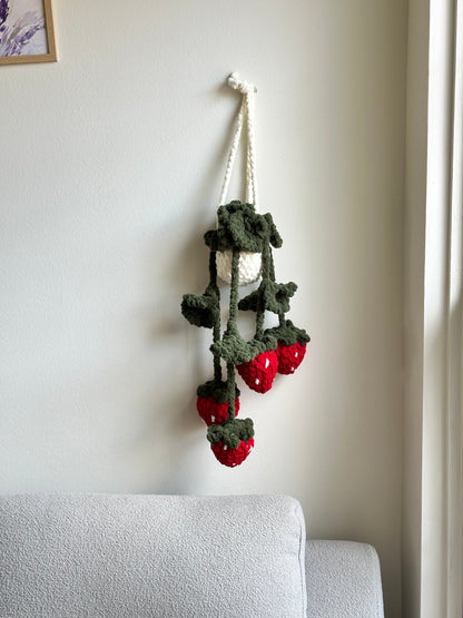 Crochet plush hanging plant with strawberries and green leaves