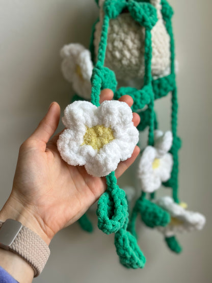 Soft crochet plant with white daisies and green leaves