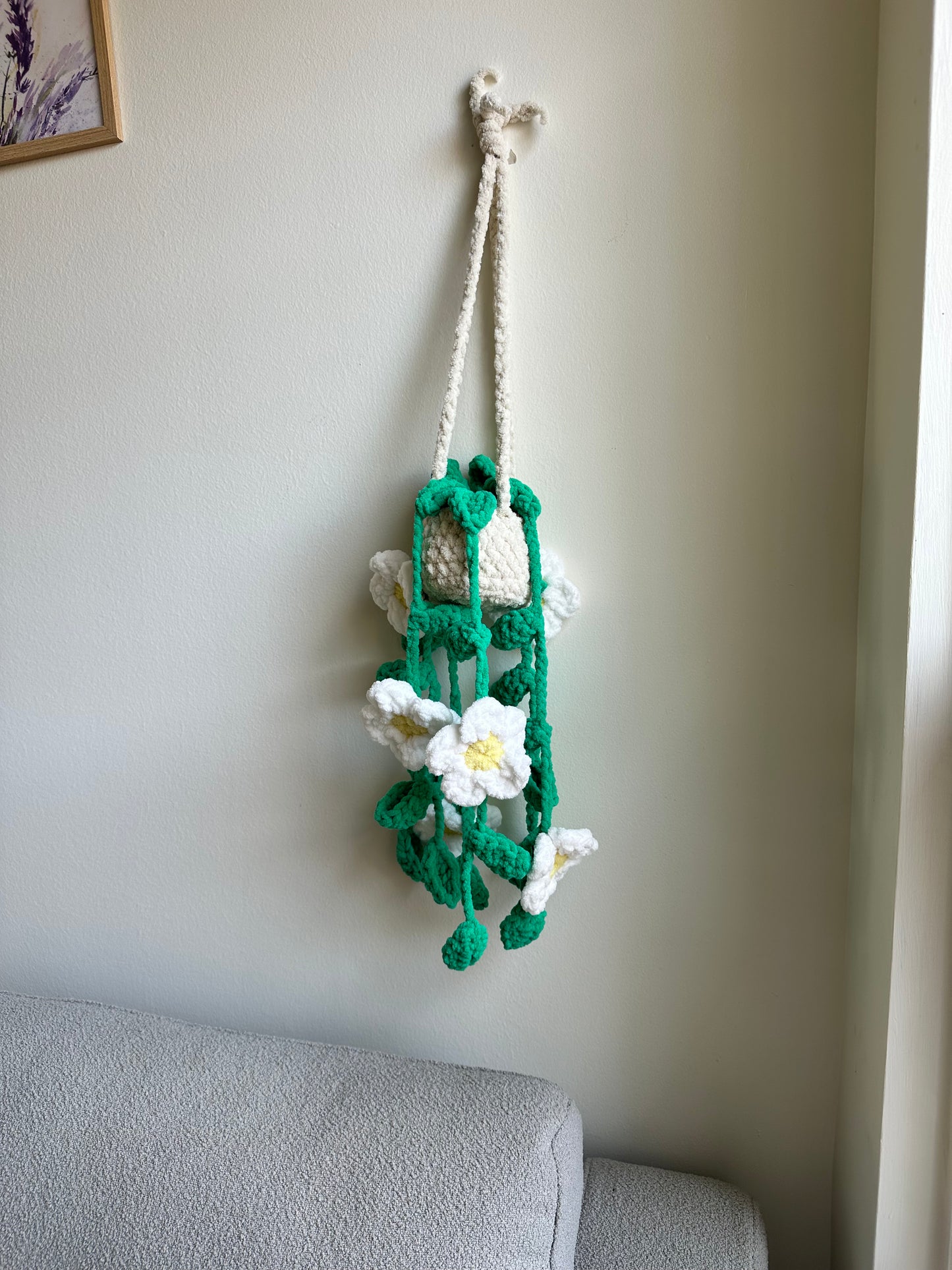 Decorative plushie flower arrangement on a wall by Mary Room