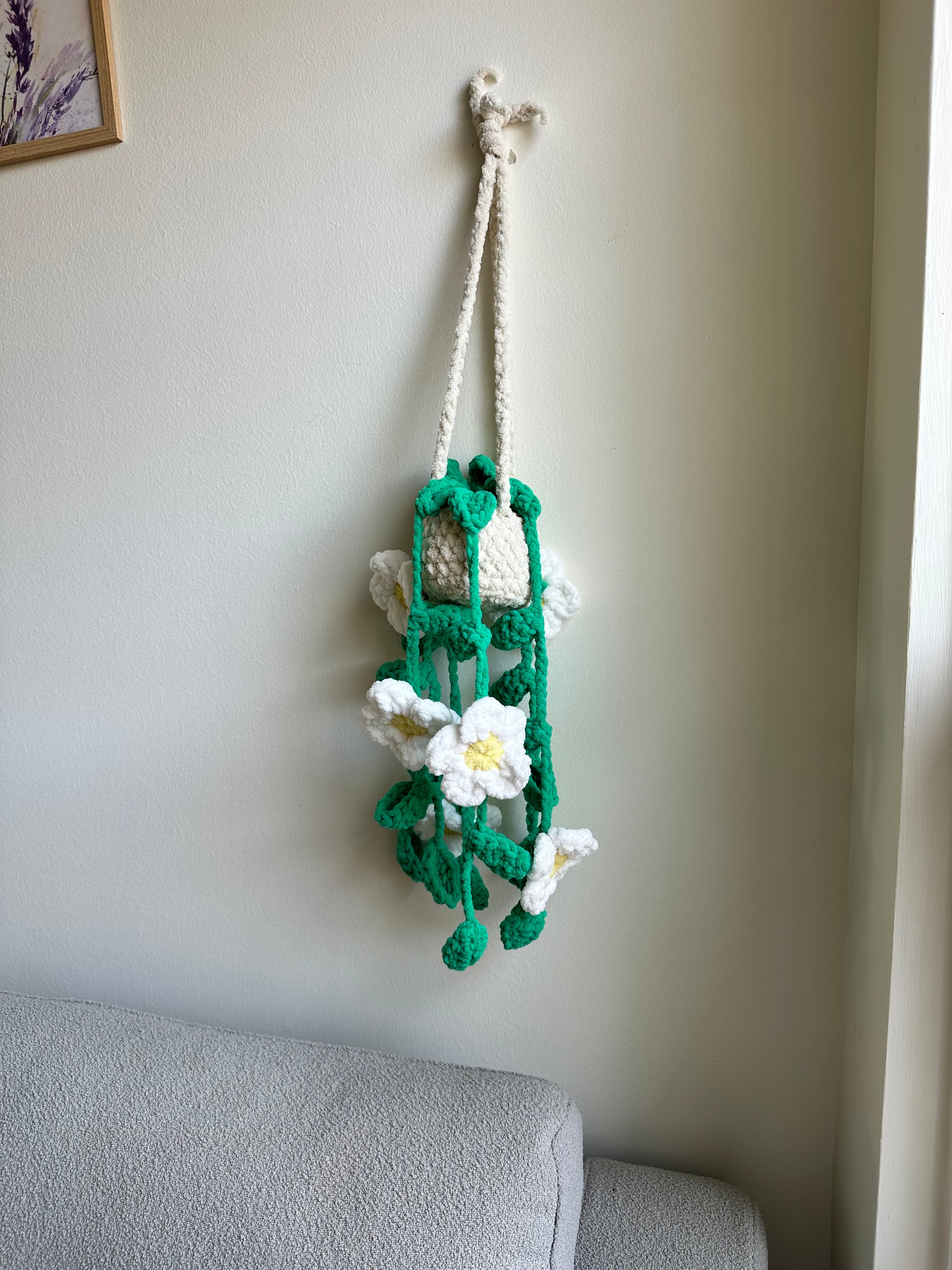 Decorative plushie flower arrangement on a wall by Mary Room