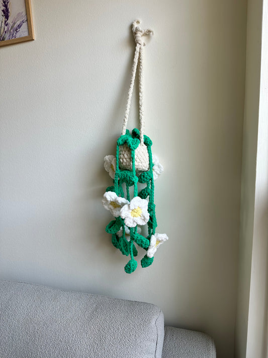 Decorative plushie flower arrangement on a wall by Mary Room