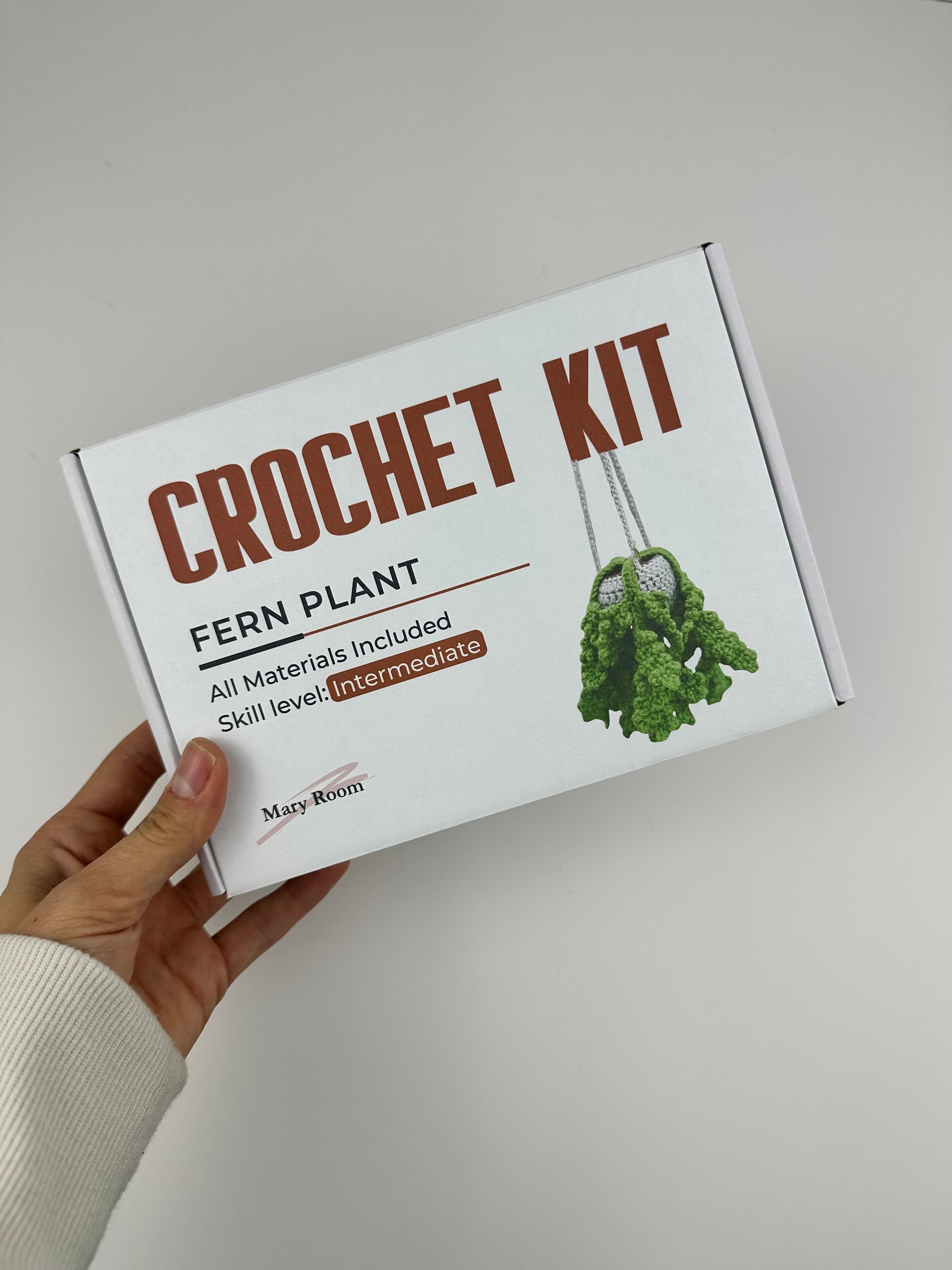 Crochet fern plant pattern with step-by-step instructions and video tutorial access.