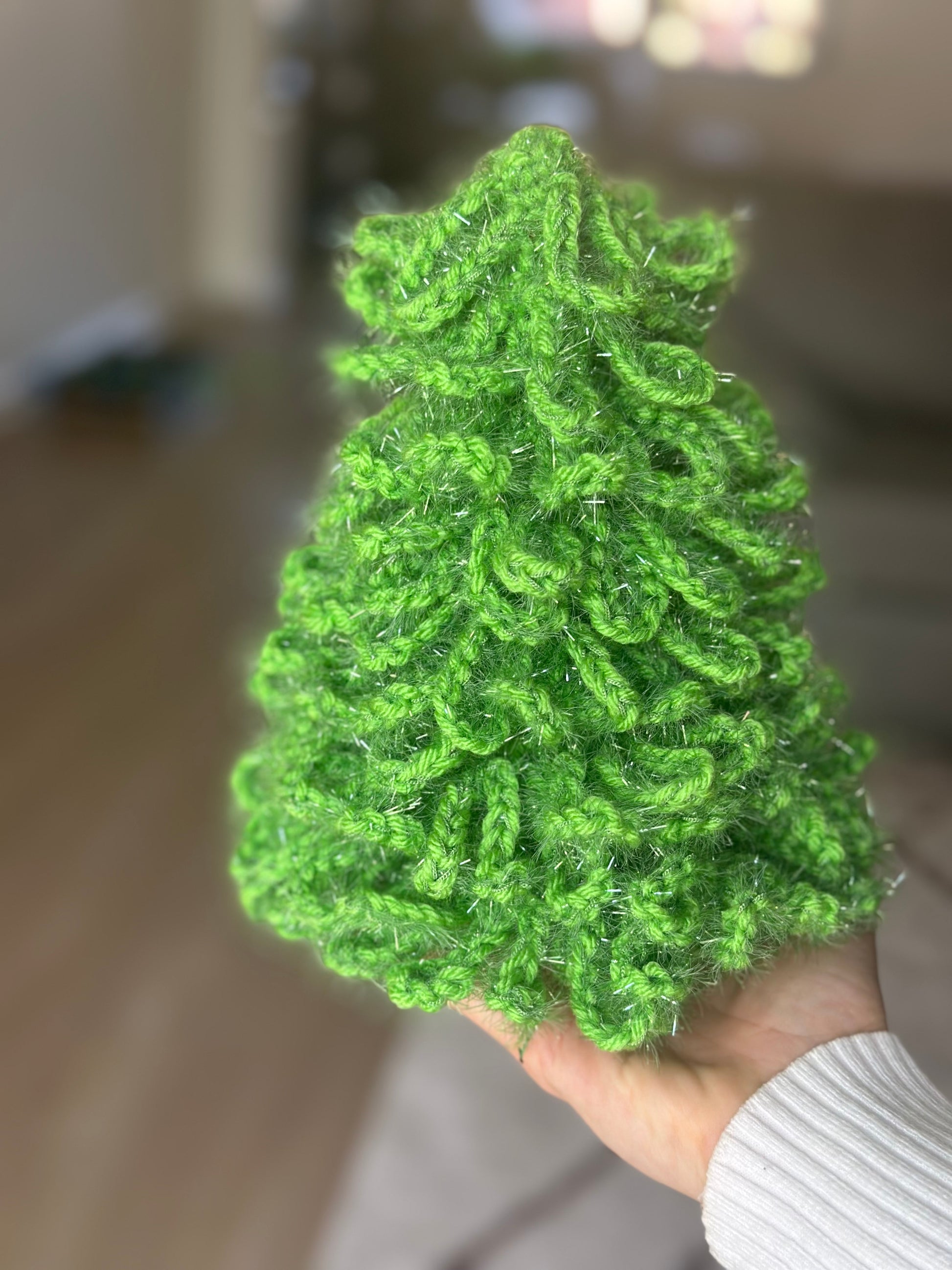 Handmade shiny green crochet Christmas tree ornament for festive home decoration