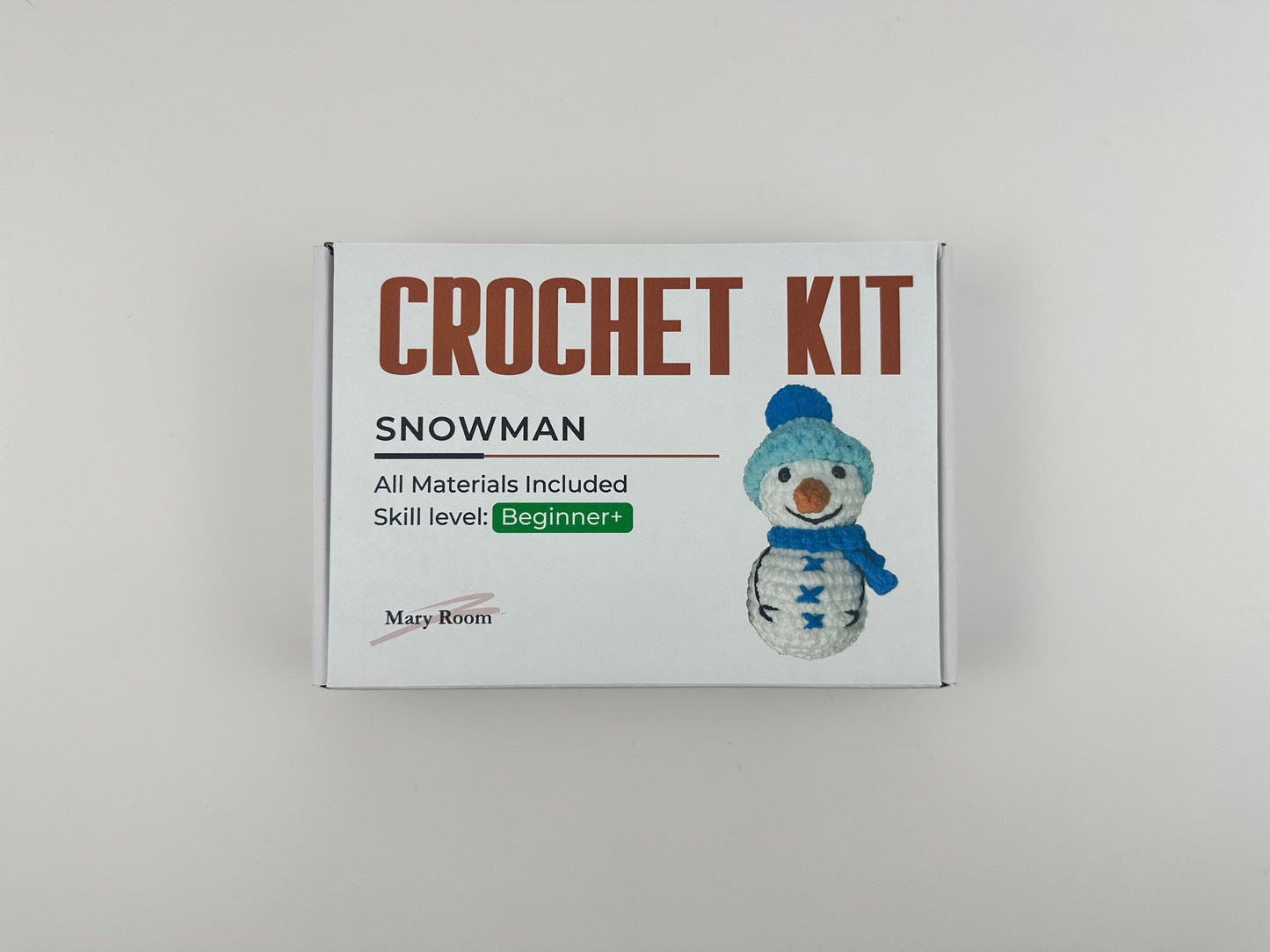 Snowman amigurumi crafting kit with soft yarn and festive details
