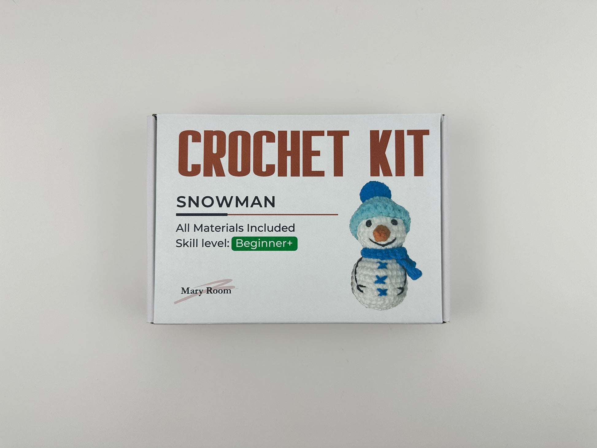 Snowman amigurumi crafting kit with soft yarn and festive details