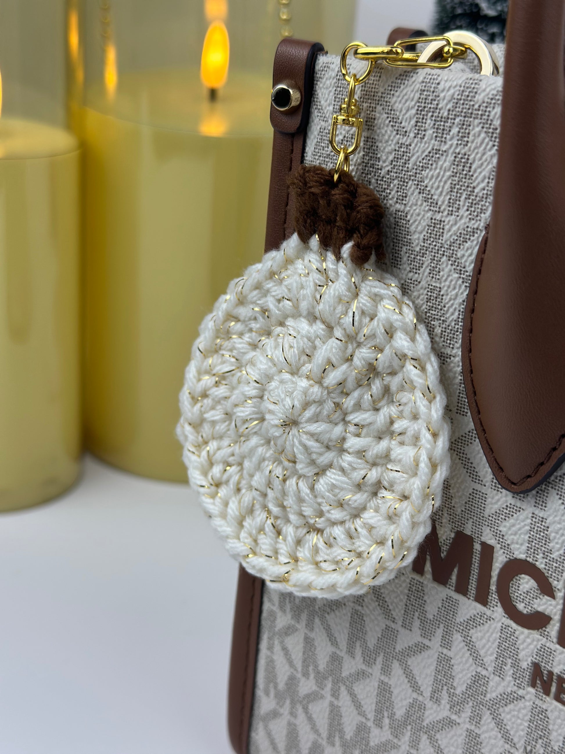 Winter-themed crochet ornament keychain made with glittery white yarn.