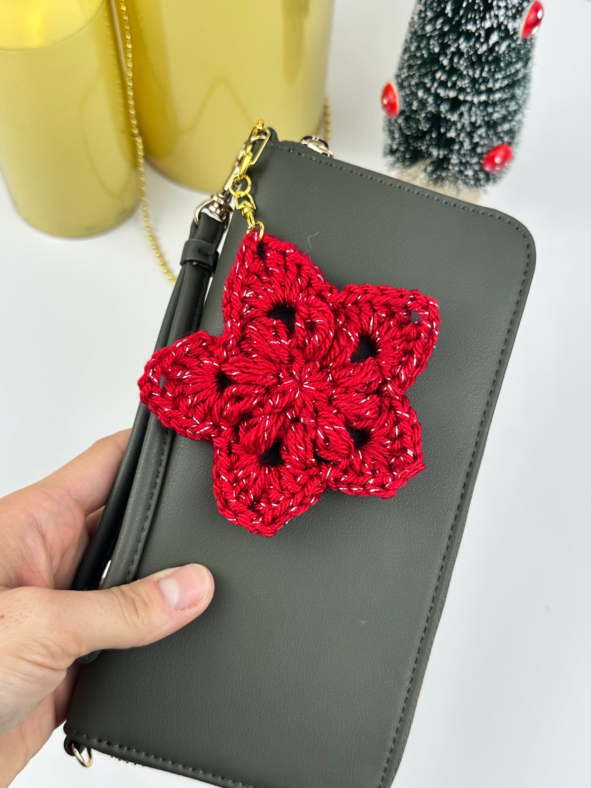 Crochet star ornament keychain for Christmas gifts, shown in beige yarn with a simple cozy design