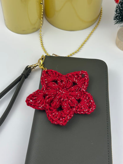 Small crocheted star charm for keys, backpacks, or bags, photographed close-up for detail