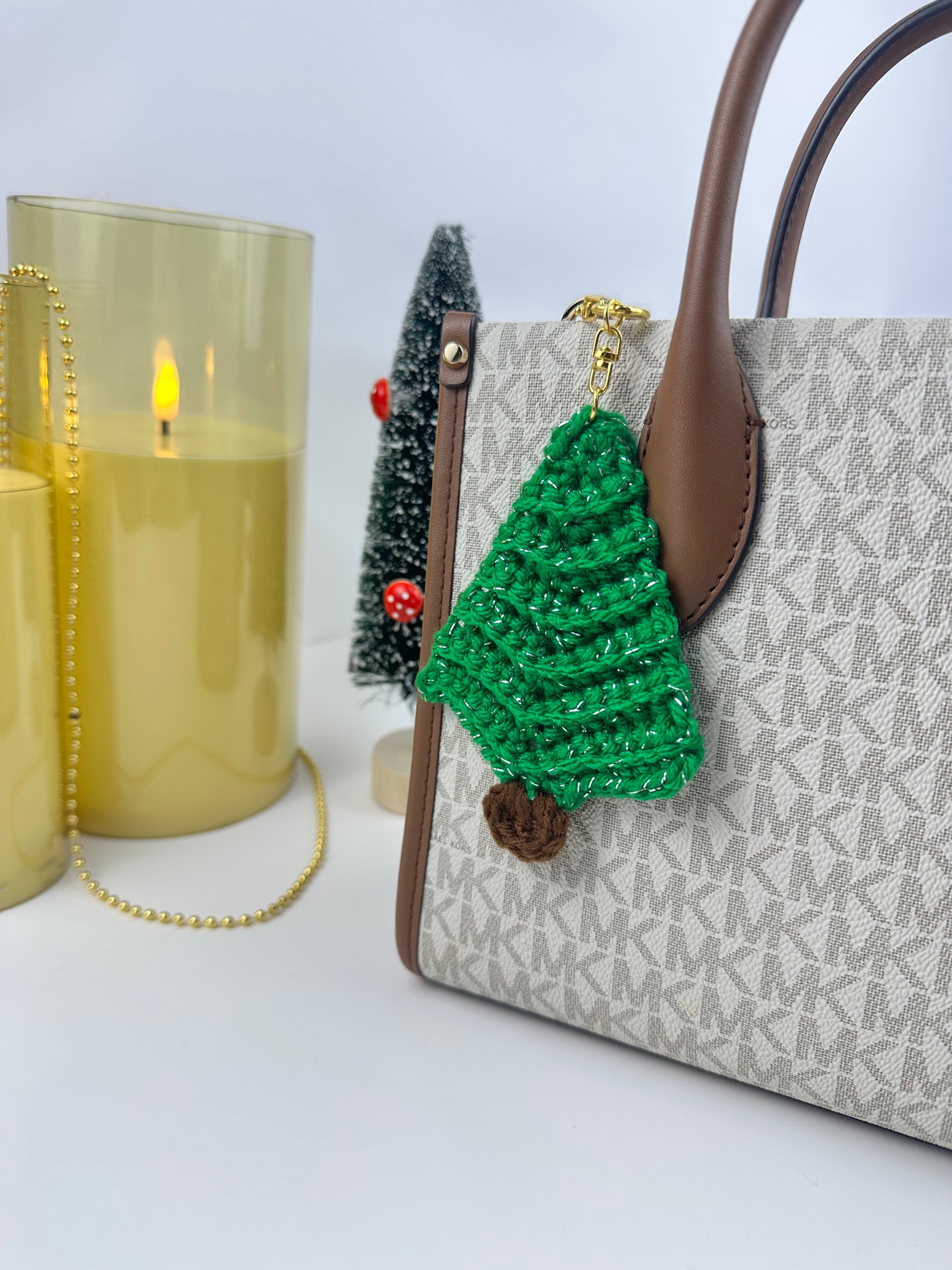 Handmade green crochet Christmas tree keychain with sparkling yarn and metal clasp