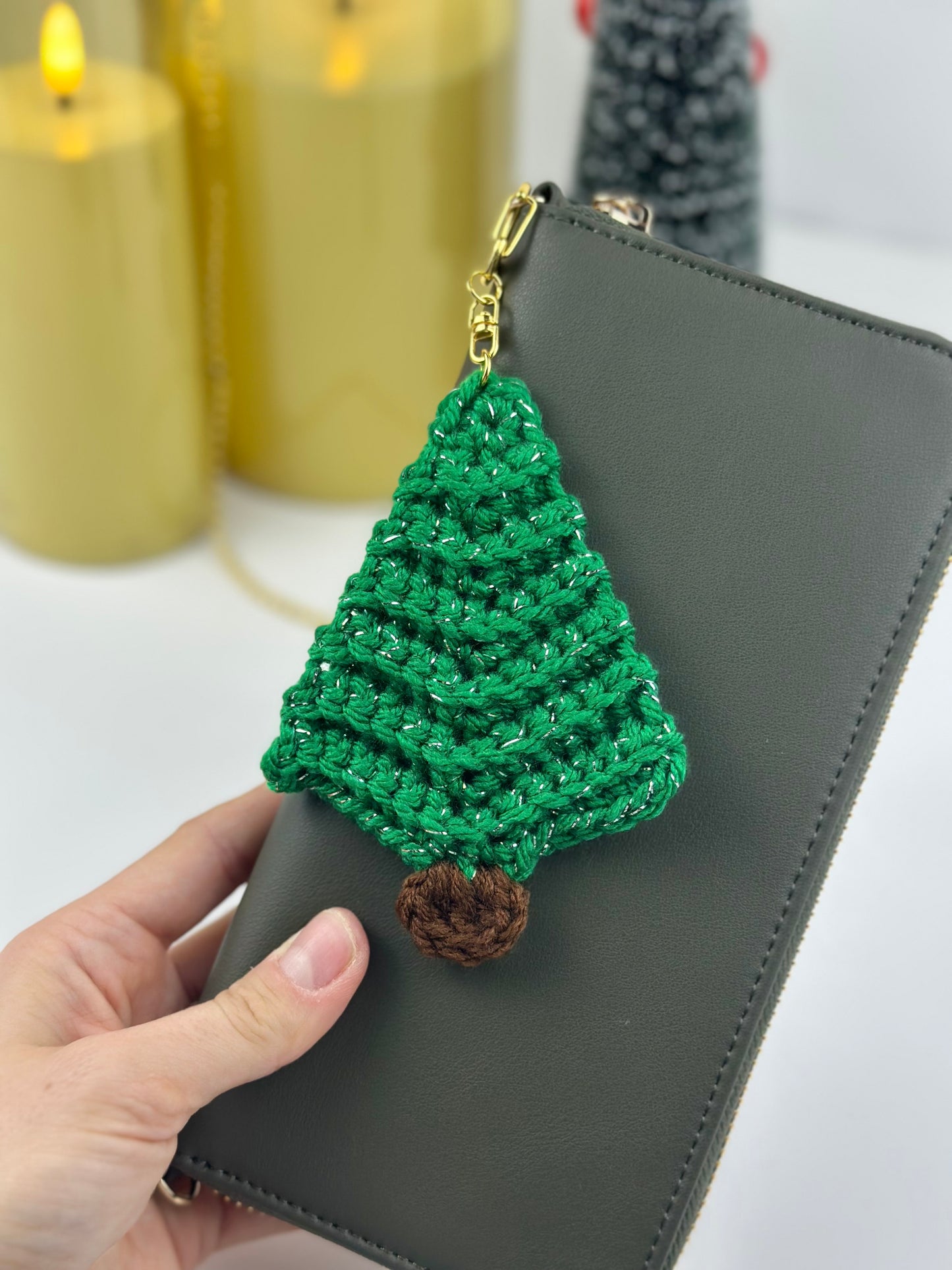 Festive mini crochet tree keychain ornament made with shiny green yarn