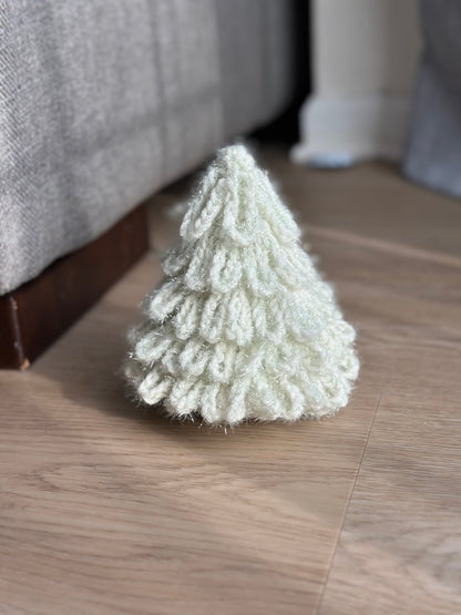 Crochet Christmas tree ornament in soft white, cozy winter decoration.