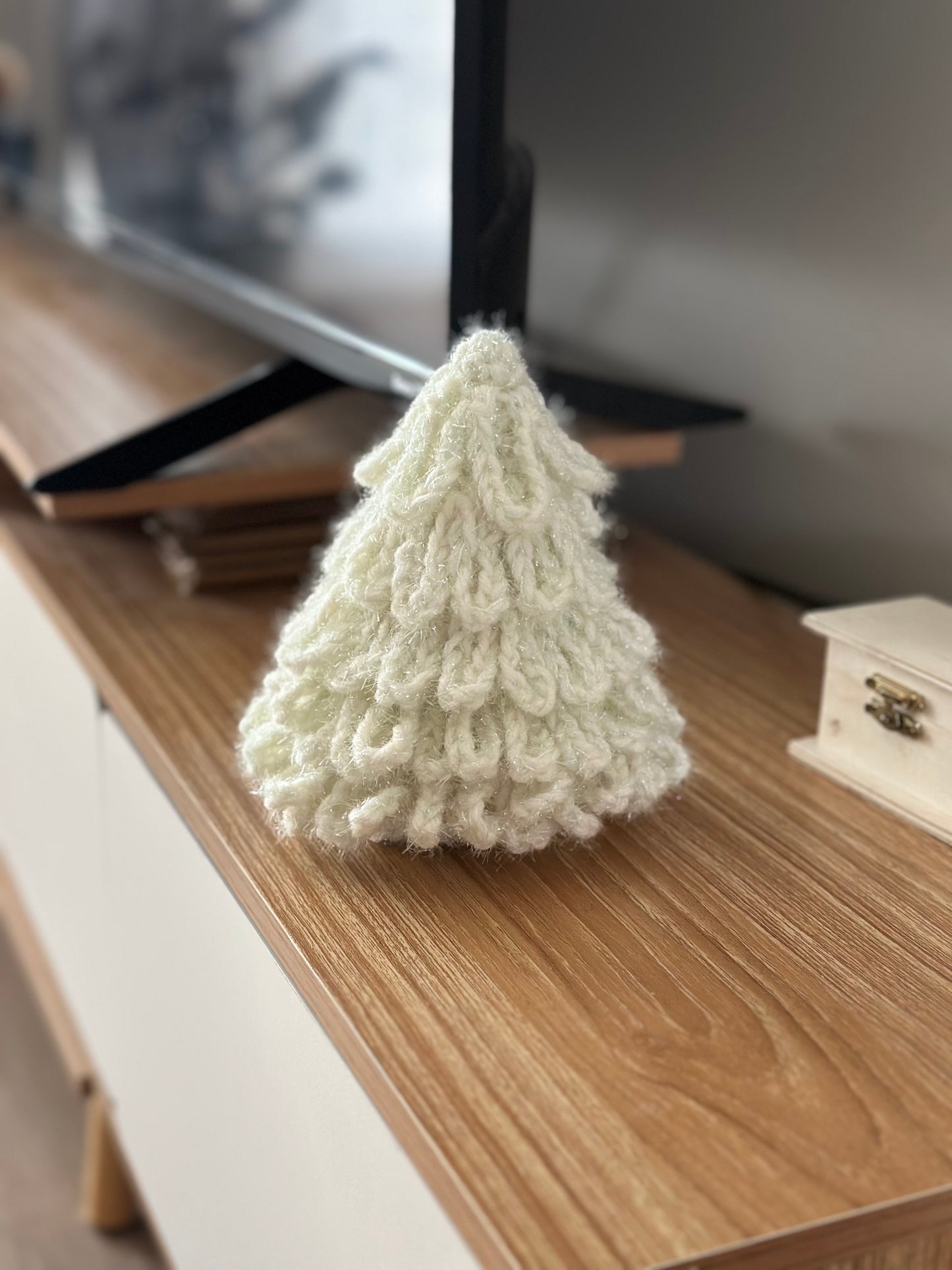 Cozy white crochet Christmas tree decoration with layered loops.