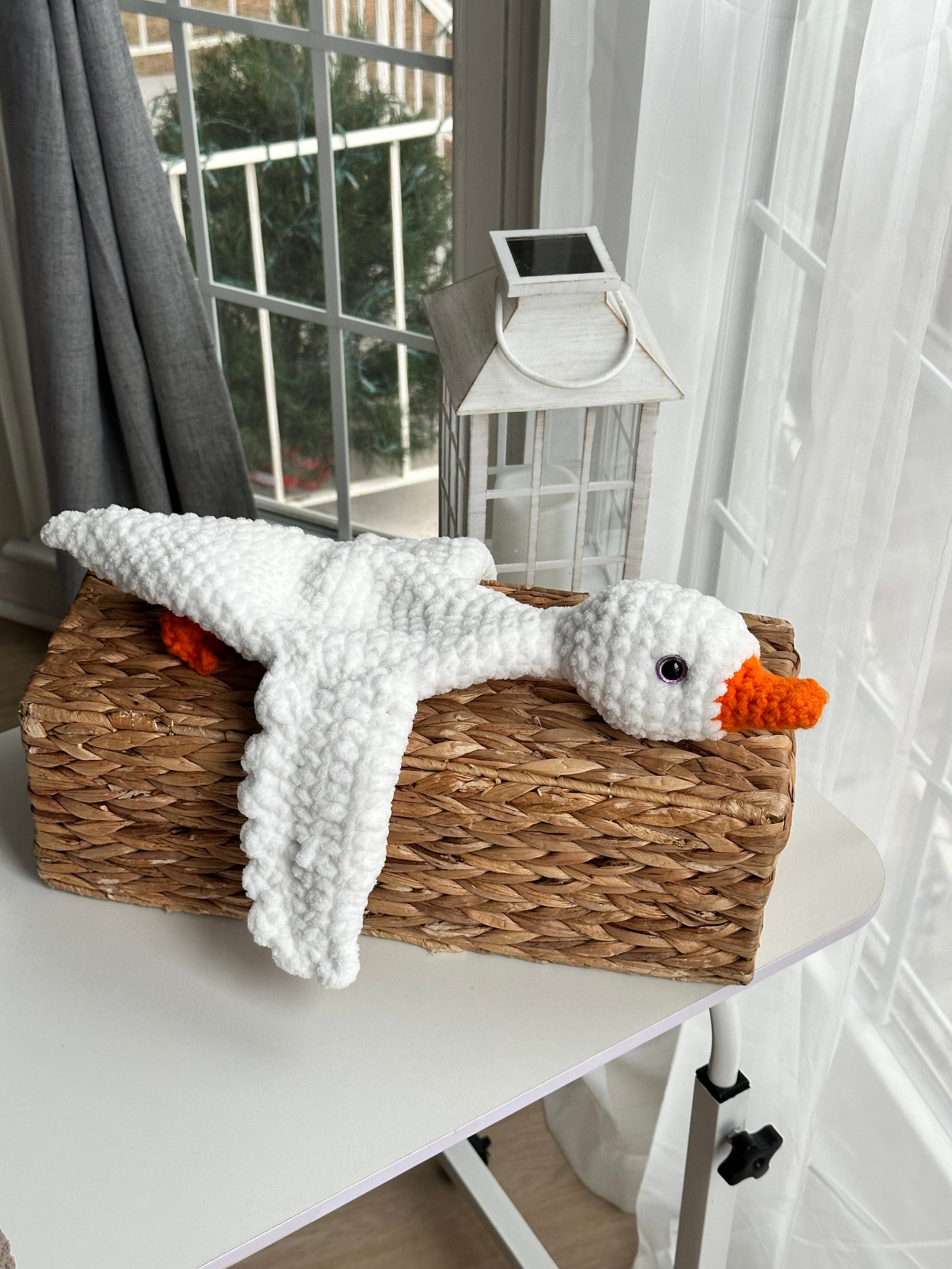 Close-up of crochet goose with soft plush yarn and acrylic beak and legs