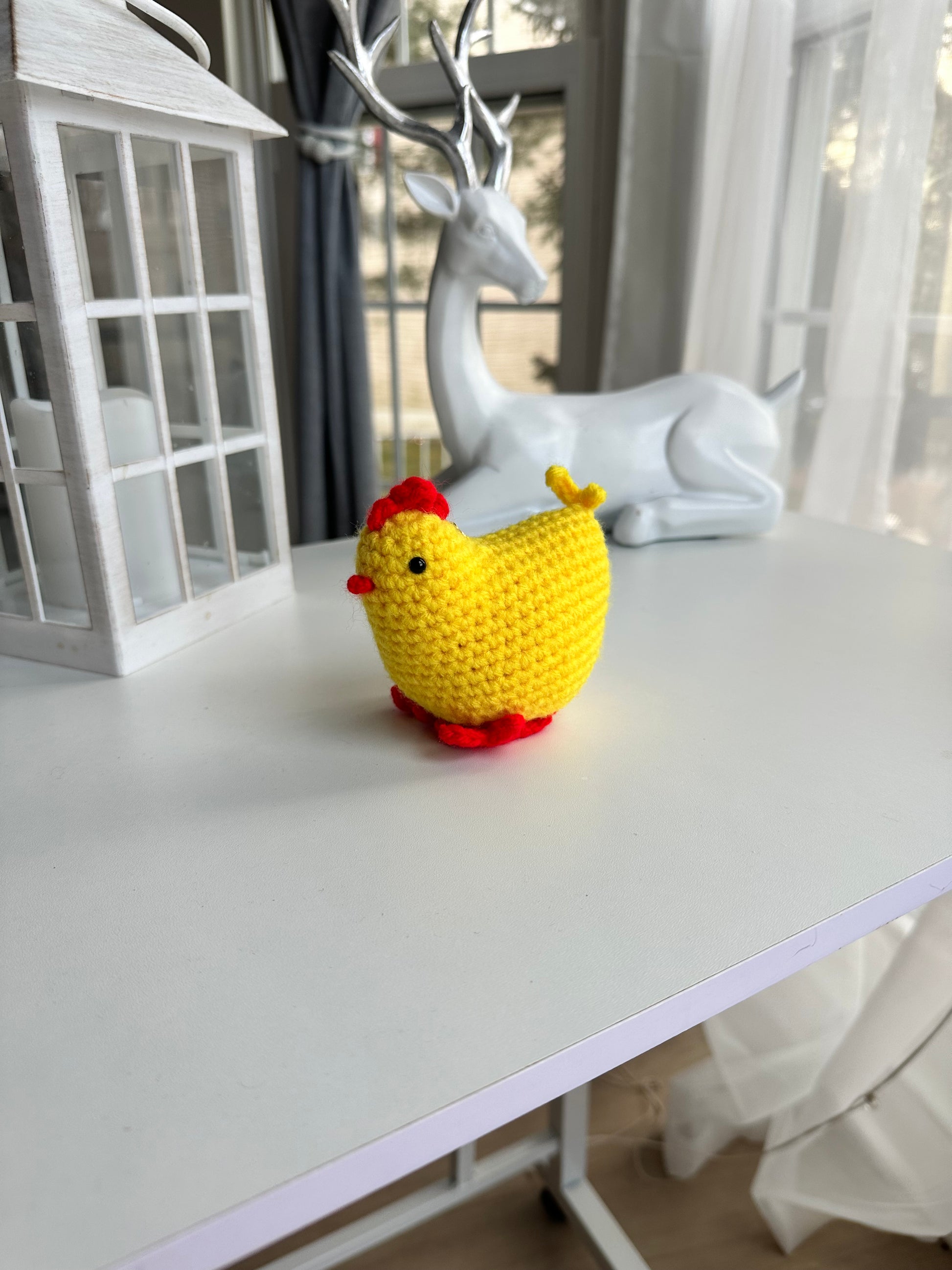 Side view of crochet chicken showing detailed wing and tail stitching