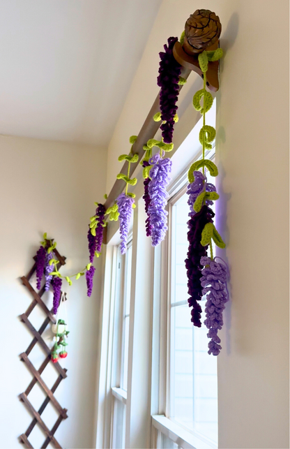 Decorative wisteria plant on a wooden trellis against a white wall.