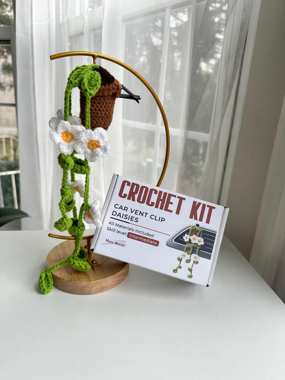 Daisy car clip kit displayed on a stand with box and contents, crochet diy kit with sachet of lavender and metal clip