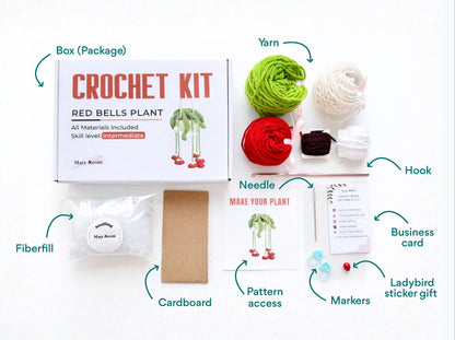 Flat lay of kit contents – yarn, hook, fiberfill, tools, and instruction card labeled DIY Crochet Kit Red Bells Plant.